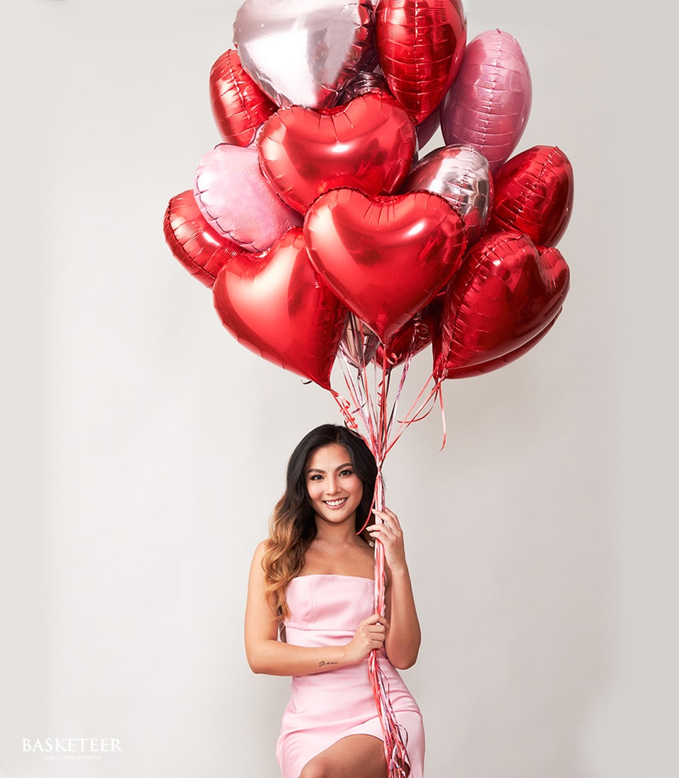 Heart-shaped red and pink foil balloons with silver accents tied in luxe gift bundle