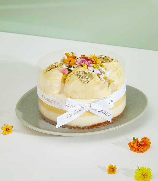 Royal Durian Crown cheesecake with gold leaf and fresh flowers, luxury celebration cake by Charlotte Bakery