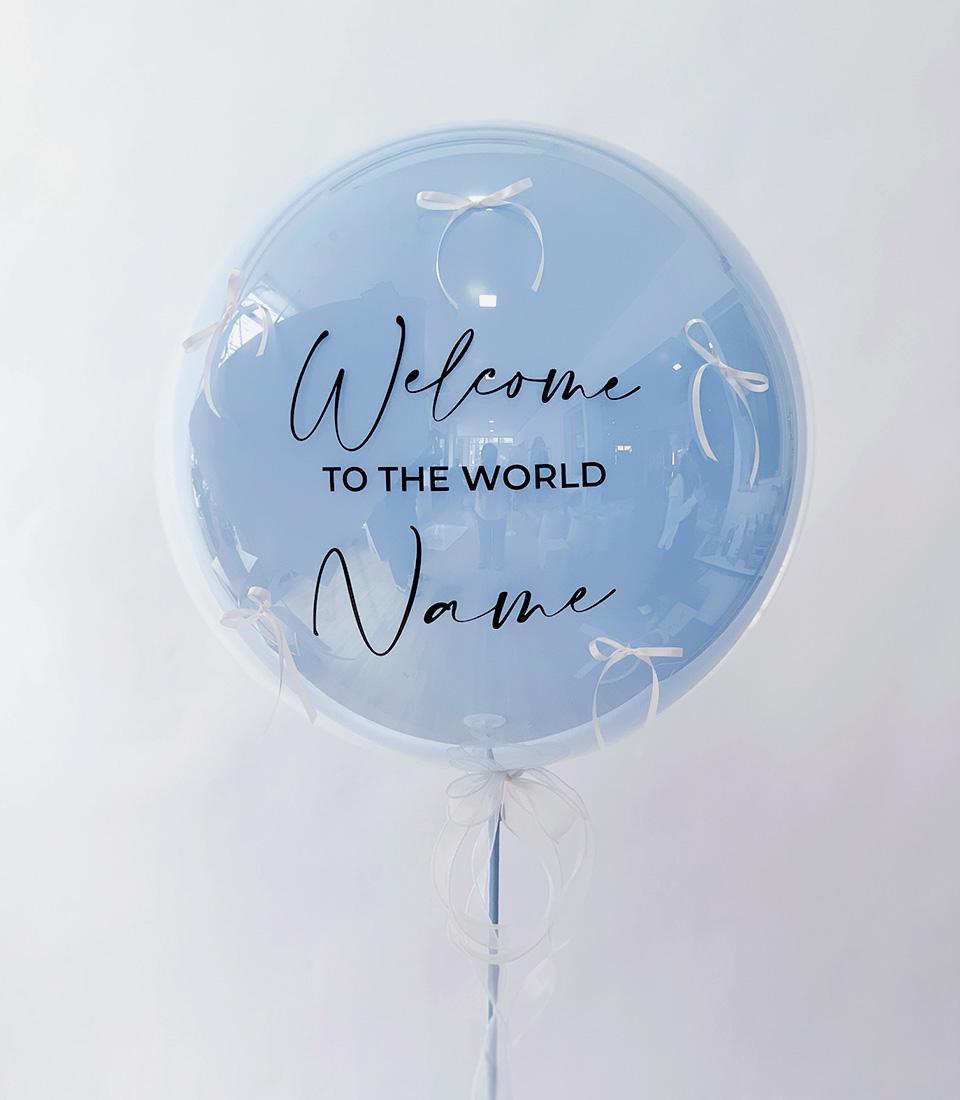 Light blue bubble balloon with white ribbon bows and "Welcome to the World" text for newborns