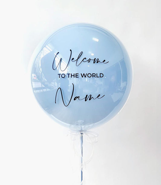 Personalised blue welcome balloon with custom name space and white ribbon bow