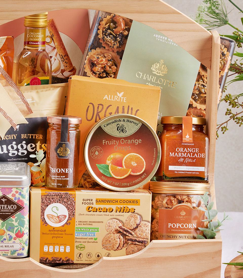 Wooden gourmet gift hamper with organic cookies, nuts, tea, honey, and marmalade