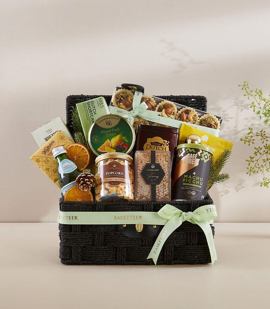 Premium black woven gift basket with gourmet treats, honey, nuts and sparkling water tied with green ribbon for New Year