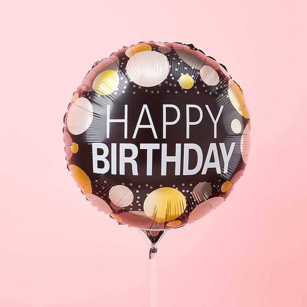 A black "Happy Birthday" balloon with gold and white polka dots, a festive add-on for your Basketeer luxury gift basket Bangkok.