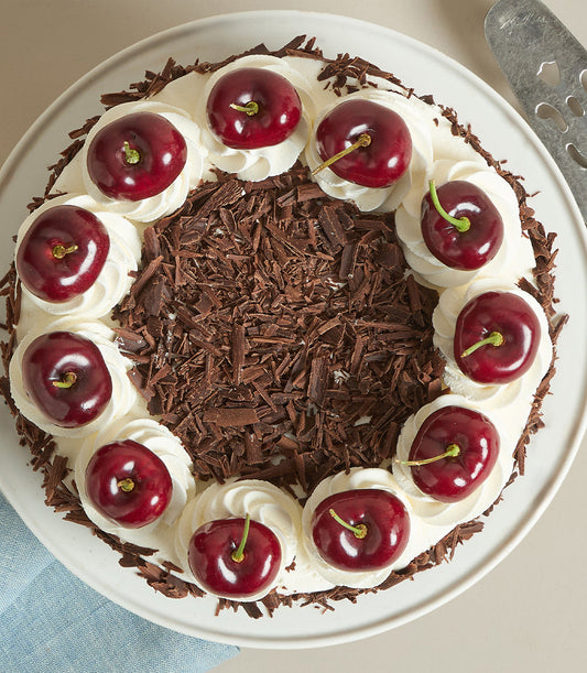 Charlotte Bakery's artisan round cake with fluffy whipped cream, dark chocolate shavings
