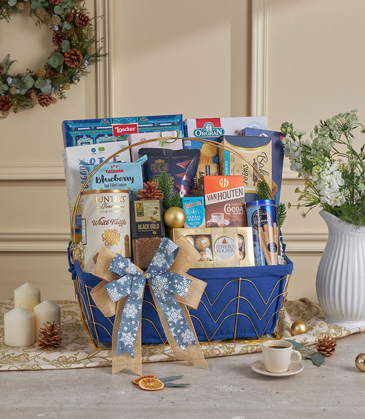 Royal blue luxury gift basket with gourmet treats, gold handles, and festive snowflake ribbon for New Year celebrations