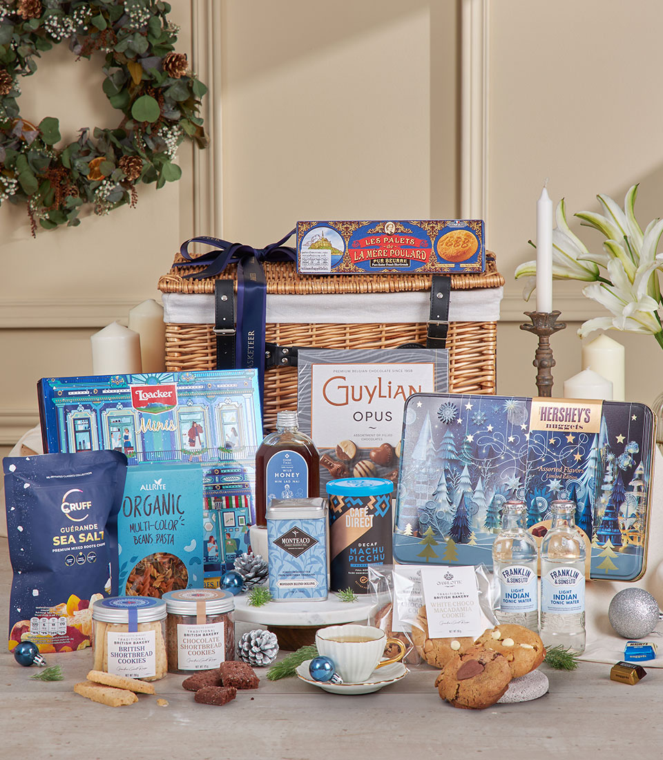 Luxurious blue wicker gift hamper filled with gourmet chocolates, artisan biscuits, specialty coffees and teas, perfect for