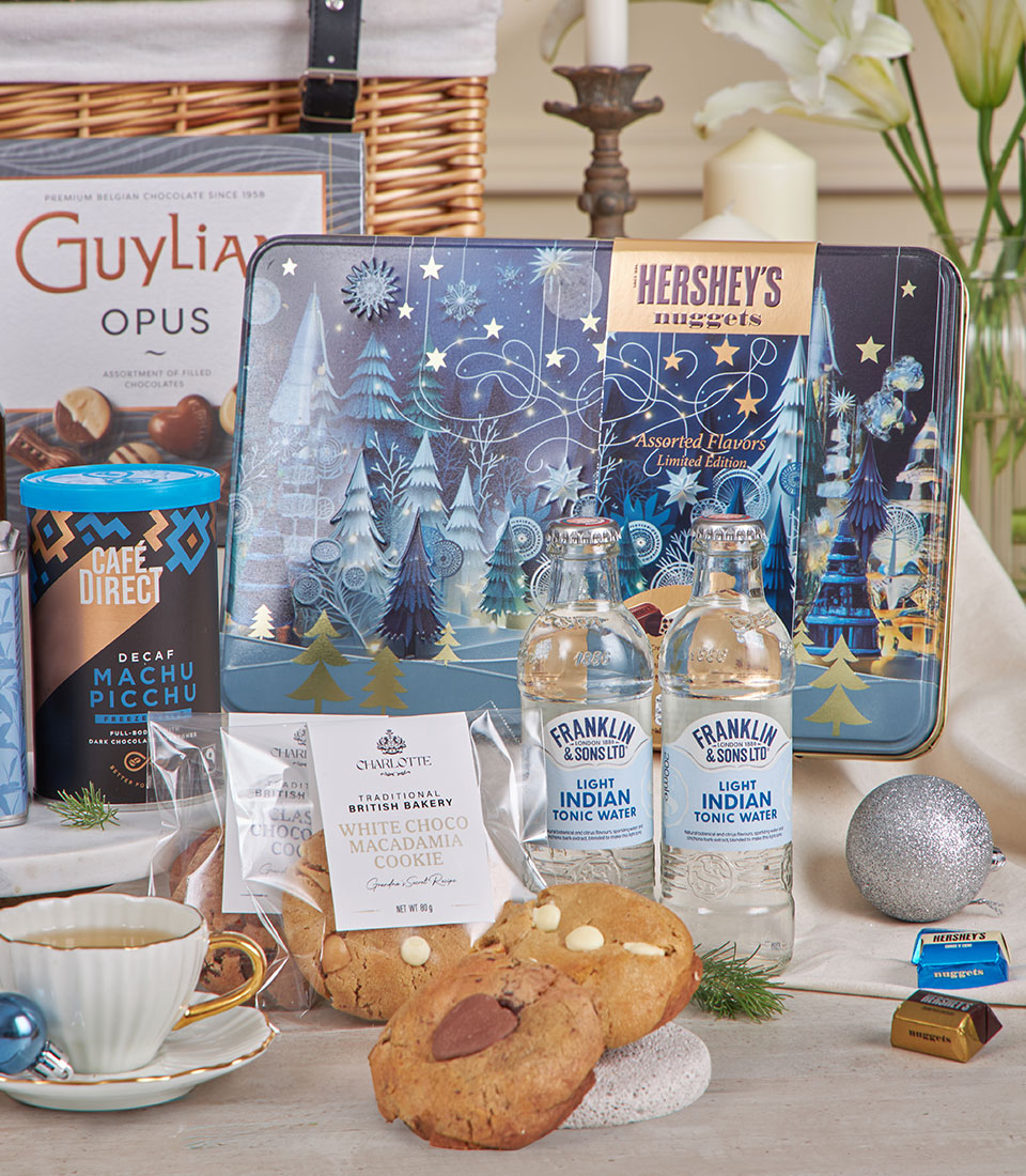 Luxury blue winter gift hamper with Belgian chocolates, artisan cookies, coffee, and tonic water for New Year