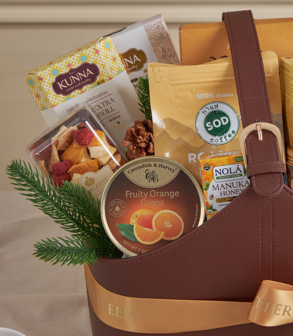 Golden Harvest premium gourmet gift basket with dried fruits, artisan coffee, and honey in faux-leather tote with gold ribbon
