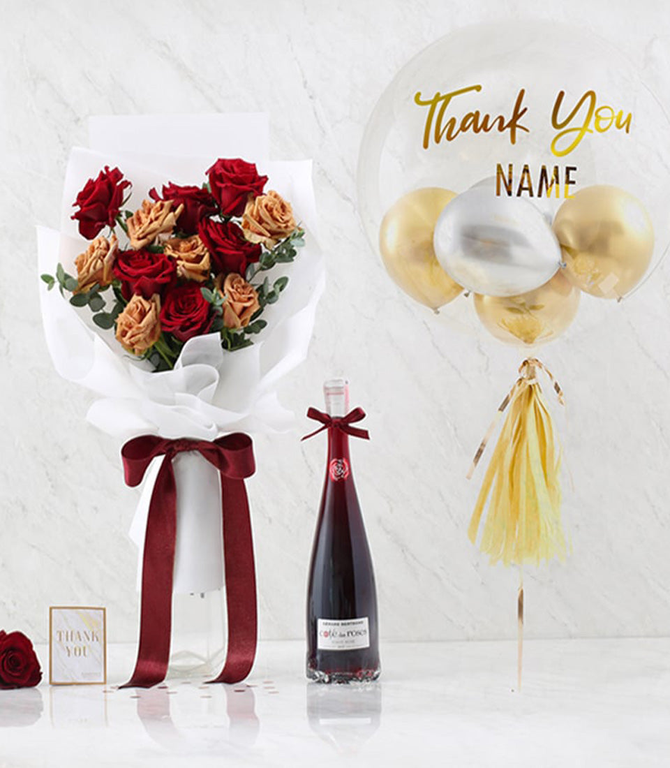 Red and peach rose bouquet with wine bottle, gold balloon, and thank you card gift set
