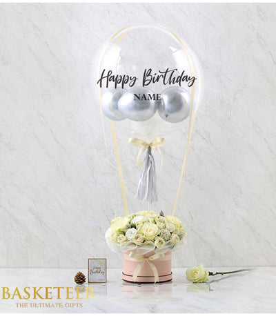 White roses with silver balloons, light pink hatbox, gold ribbons, personalized clear balloon for birthday gift combo
