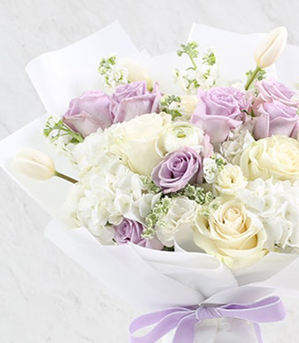 Lavender Whisper bouquet of white roses, hydrangeas, and ranunculus with Prosecco for anniversaries