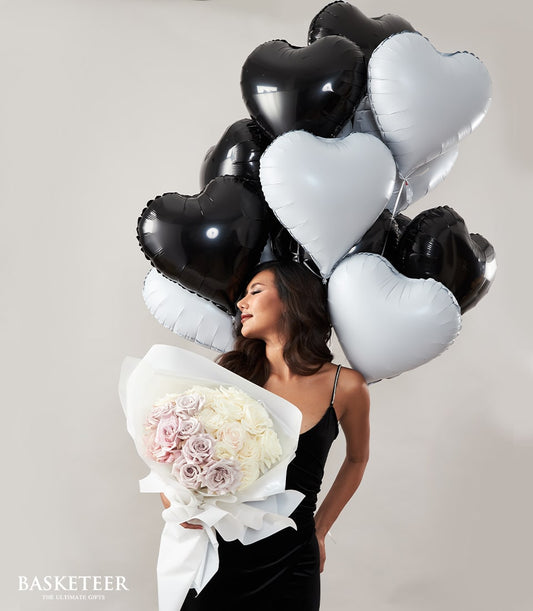 Black and white heart balloons with white and lavender roses Valentine's Day bouquet