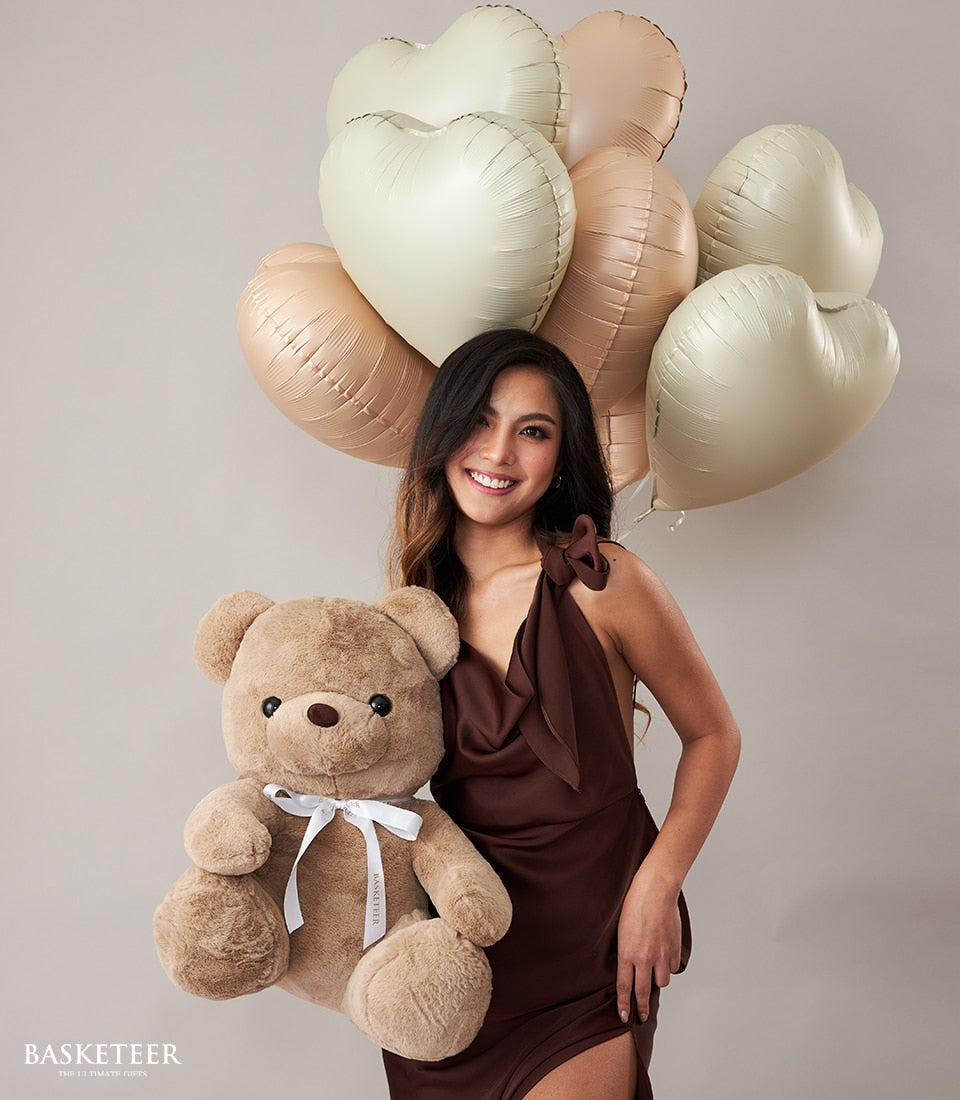 Large plush teddy bear with heart-shaped balloons in cream and blush tones, romantic birthday gift set