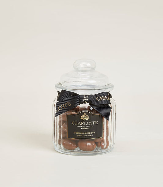 Glazed almond milk chocolate in glass Charlotte jar with gold ribbon and label