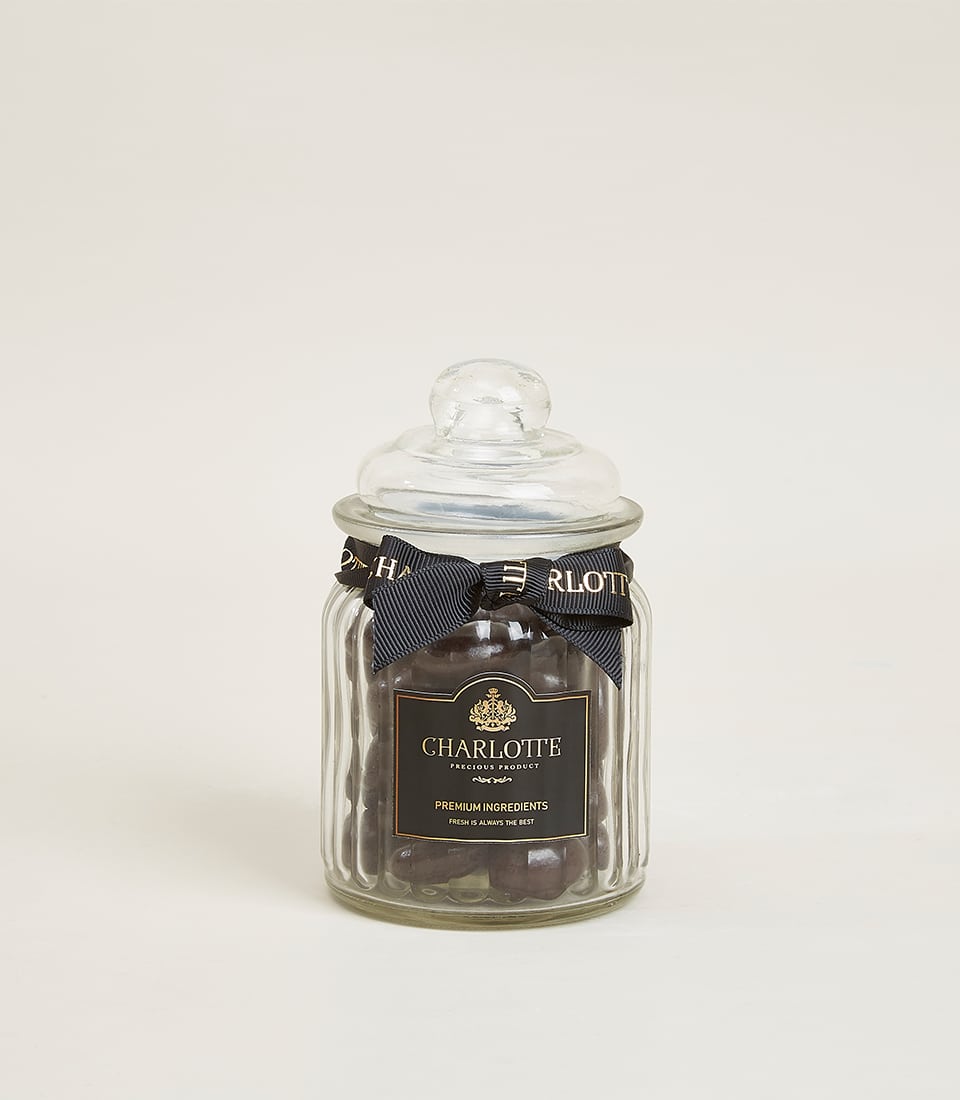 Glazed dark chocolate almond jar with gold-trimmed ribbon, premium Charlotte Bakery gift add-on