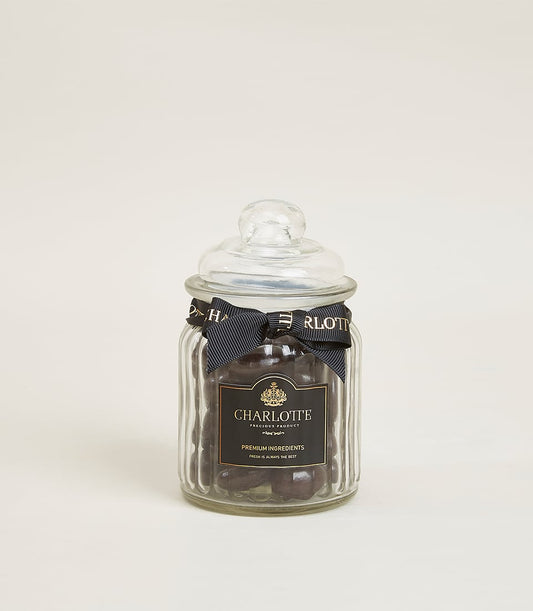 Glazed dark chocolate almond jar with gold-trimmed ribbon, premium Charlotte Bakery gift add-on