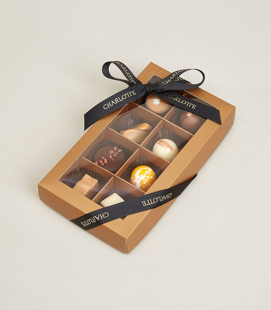 Premium assorted pralines and truffles in luxury gift box with Charlotte Bakery ribbon