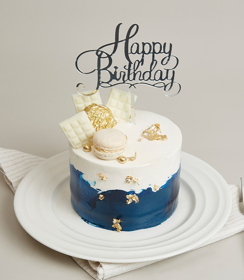 White chocolate and blue birthday cake quarter pound with gold leaf and macarons
