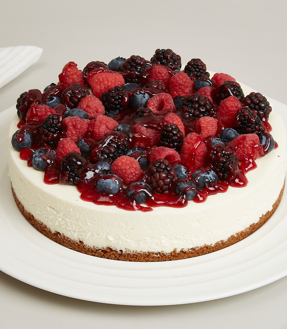 Berry Cheesecake Delight with fresh raspberries, blueberries and blackberries on creamy white filling