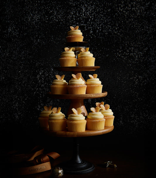 Vanilla buttercream cupcakes with candied ginger, tiered Christmas display on wooden stand