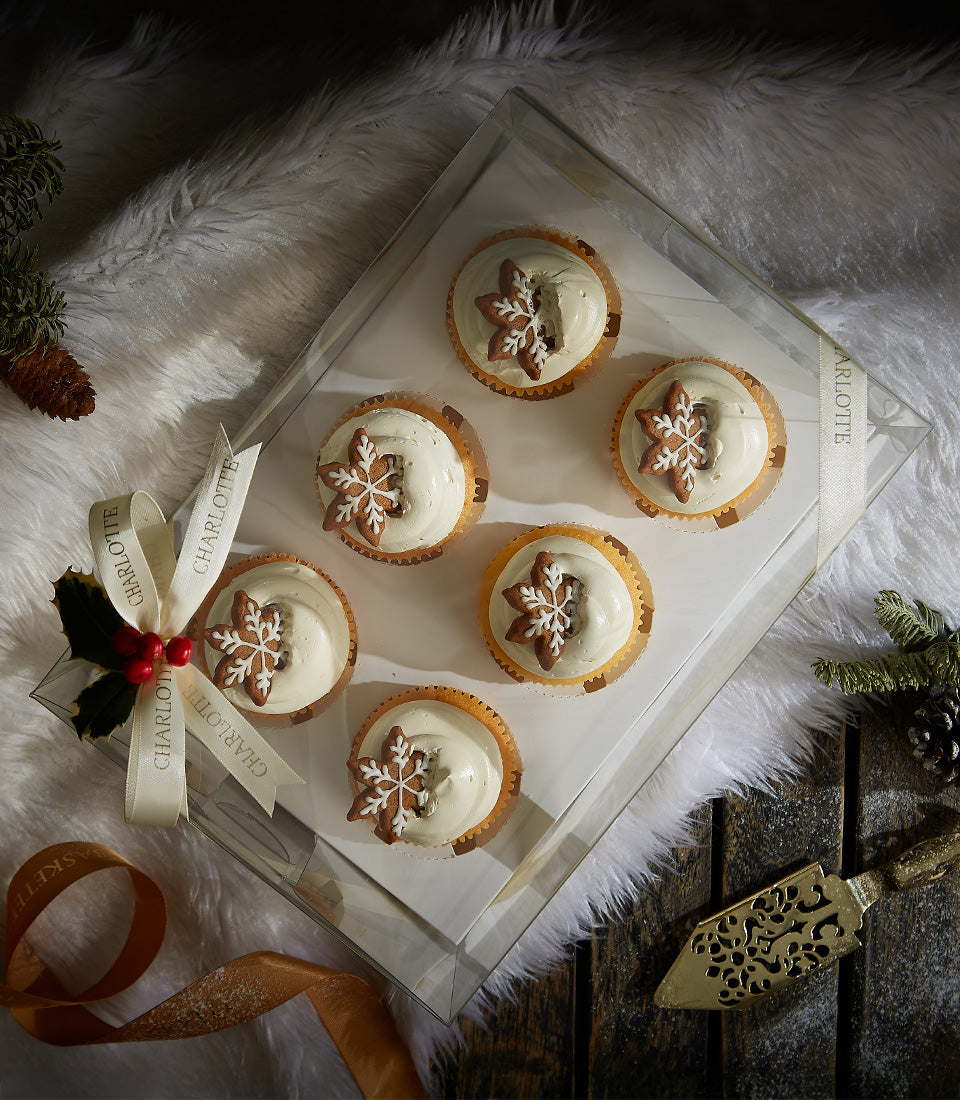 Biscoff cream cupcakes with gingerbread snowflake toppers in Christmas gift box with ribbon
