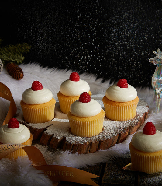 White vanilla cupcakes with raspberry and frosting swirls, Christmas bakery gift box from Charlotte Bakery