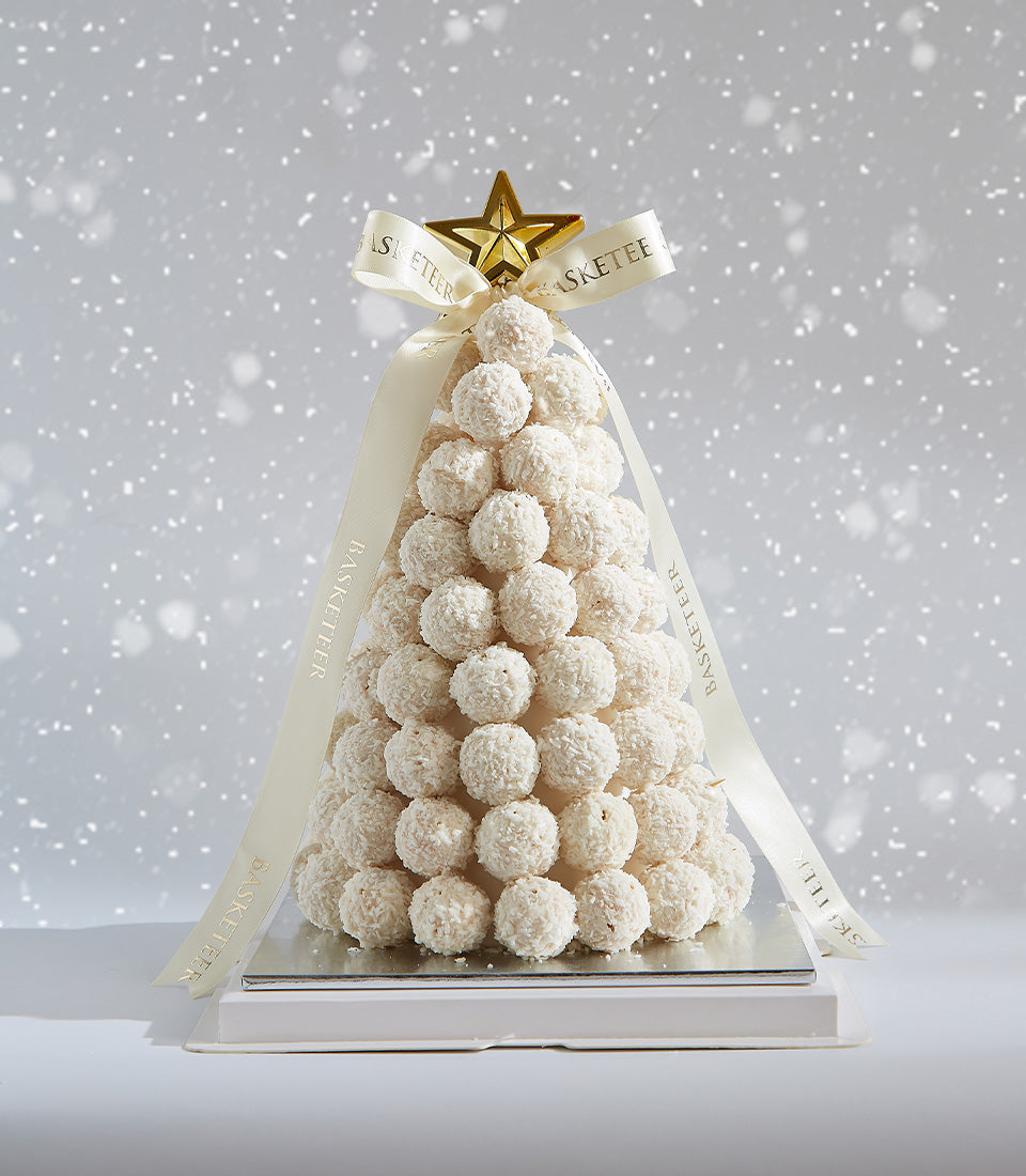 Ferrero Raffaello white truffle Christmas tree with coconut coating, golden star topper, and cream ribbon on silver base