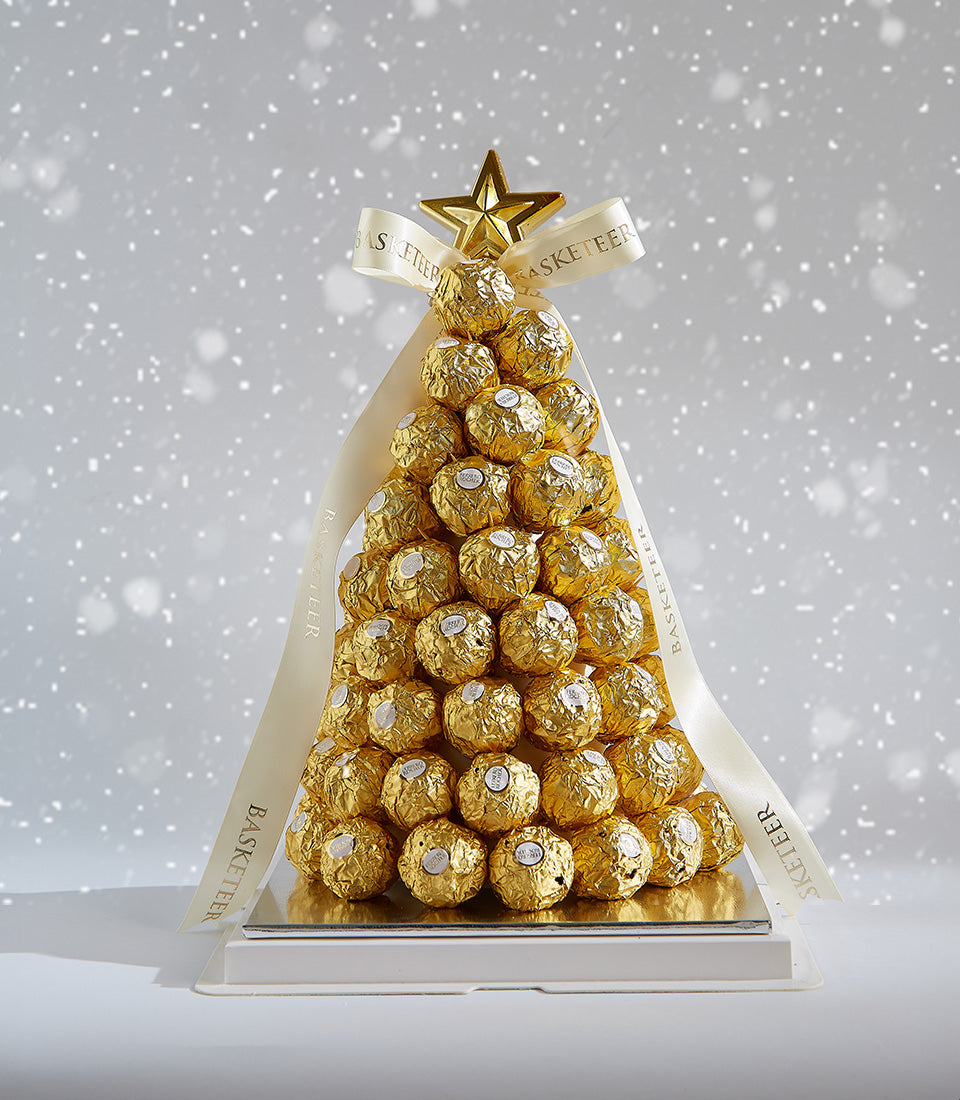 Golden Ferrero Rocher chocolate Christmas tree with cream ribbon and star ornament on tiered base