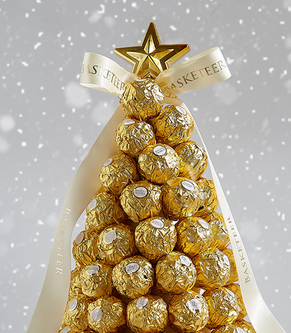 Golden Ferrero Rocher Christmas tree with cream ribbon bow and star topper