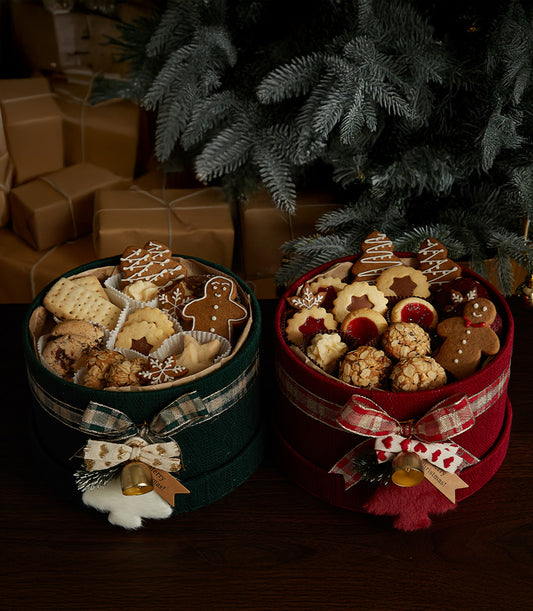 Festive Christmas cookie gift boxes with gingerbread, star shapes, and artisan baked assortment in green and red plaid