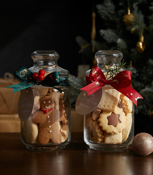 Festive Cookies Jar Duo with gingerbread and star-shaped treats, tied with green and red ribbons