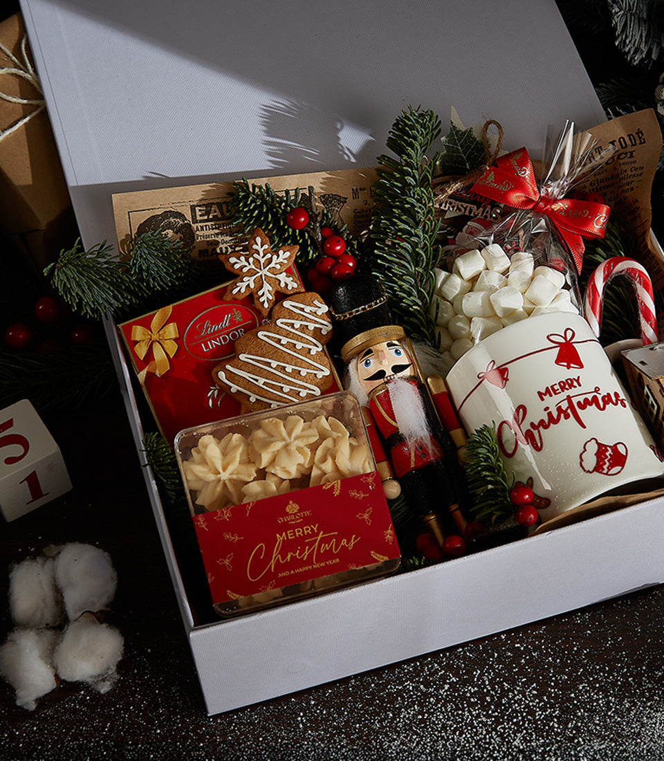 Festive Indulgence white gift box with chocolate, gingerbread cookies, butter cookies, nutcracker, mug and candy cane