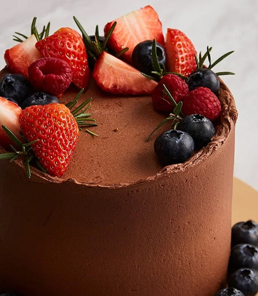 A luxurious Basketeer add-on gift: a rich chocolate cake generously topped with