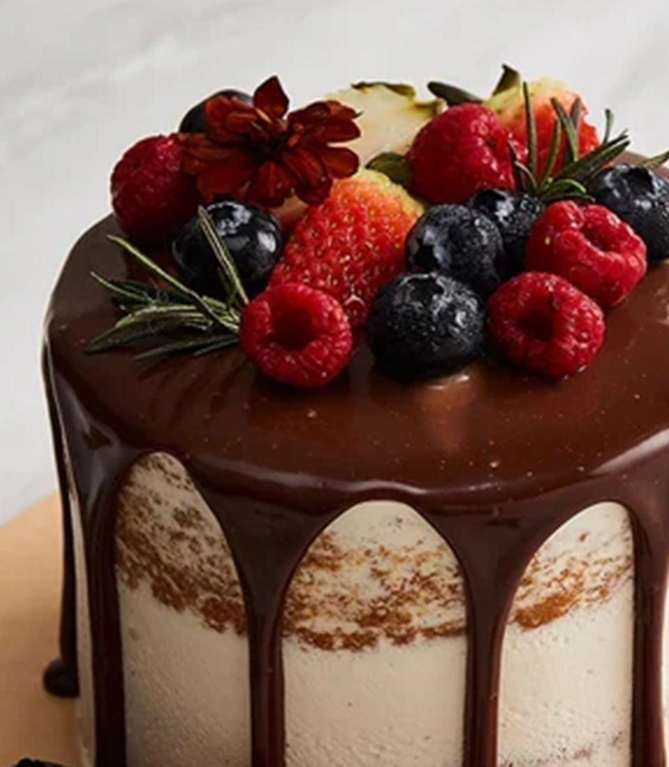 Basketeer's mini vanilla cake with rich chocolate drip, topped generously