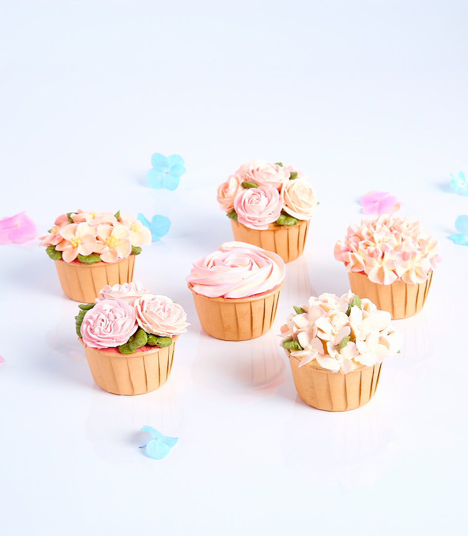 Blossom Bouquet Mother's Day cupcakes with pink rose and hydrangea buttercream flowers, light blue petals scattered