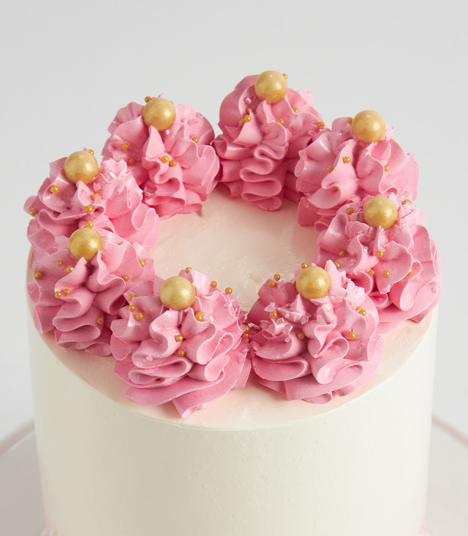 Pink buttercream rosette layer cake with gold sprinkles, perfect birthday gift for women