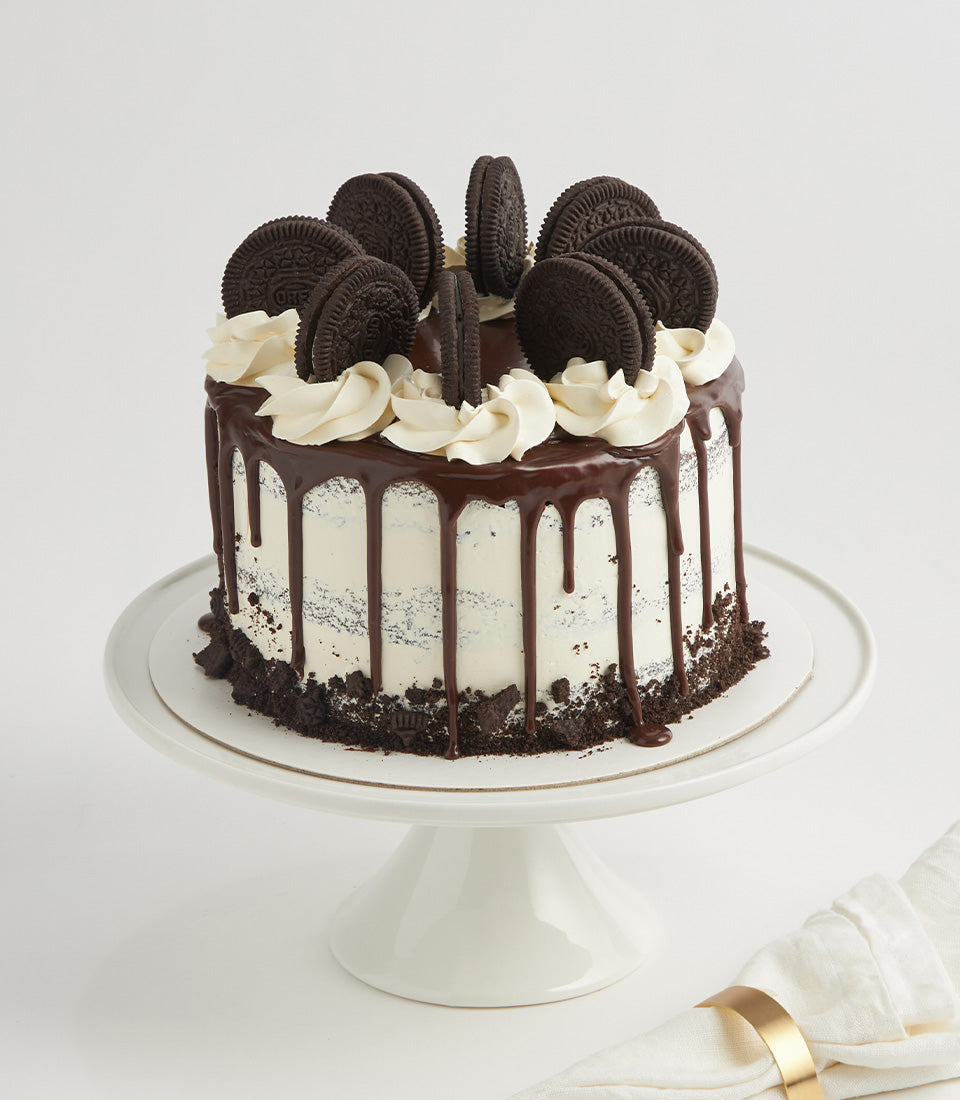 Oreo cream layer cake with chocolate ganache drip and cookie-topped frosting for birthdays
