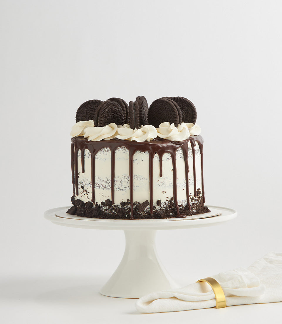 Rich Oreo Cream Layer Cake with chocolate ganache drip and cookie crumble, artisan birthday cake