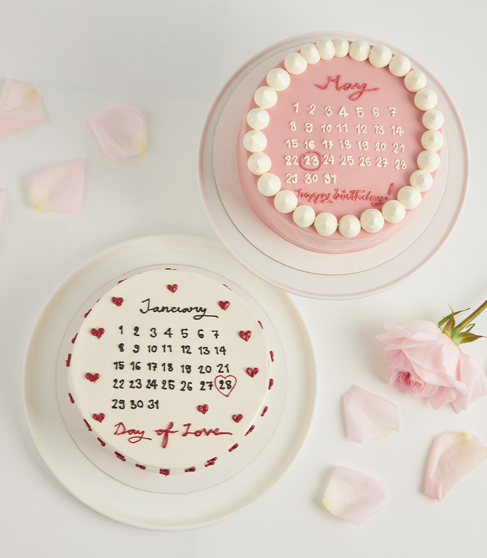 Pink and white calendar-themed birthday cakes with strawberry flavors, personalized dates, and romantic rose petal garnishes