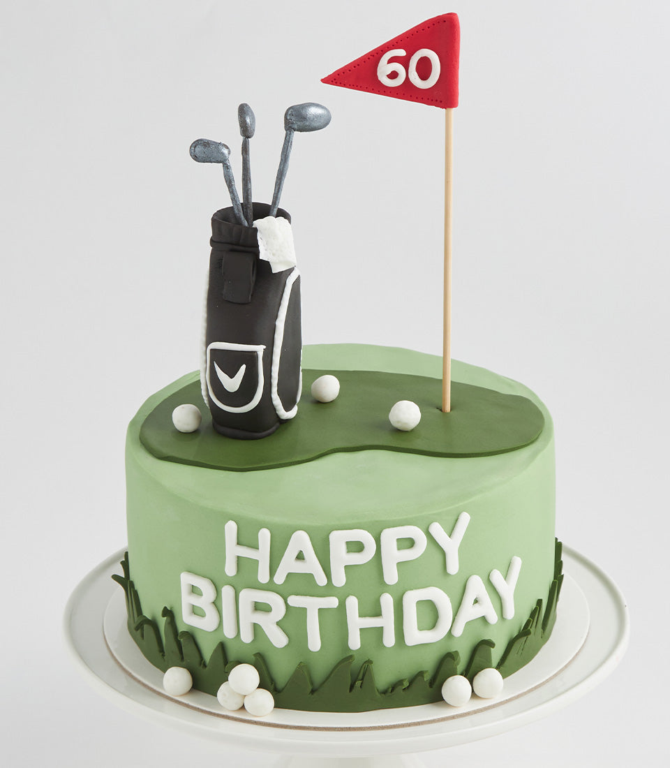 Light green layer cake with fondant golf green, black golf bag, clubs, and number 60 flag for birthday