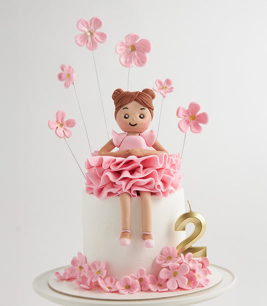 Ballerina girl fondant doll cake with pink flowers and gold number candle for 2nd birthday