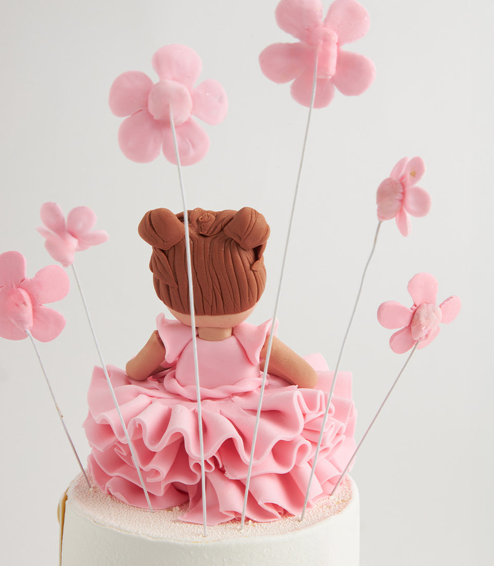 White layer cake with ballerina doll topper and pink wired flowers, custom birthday cake for girls
