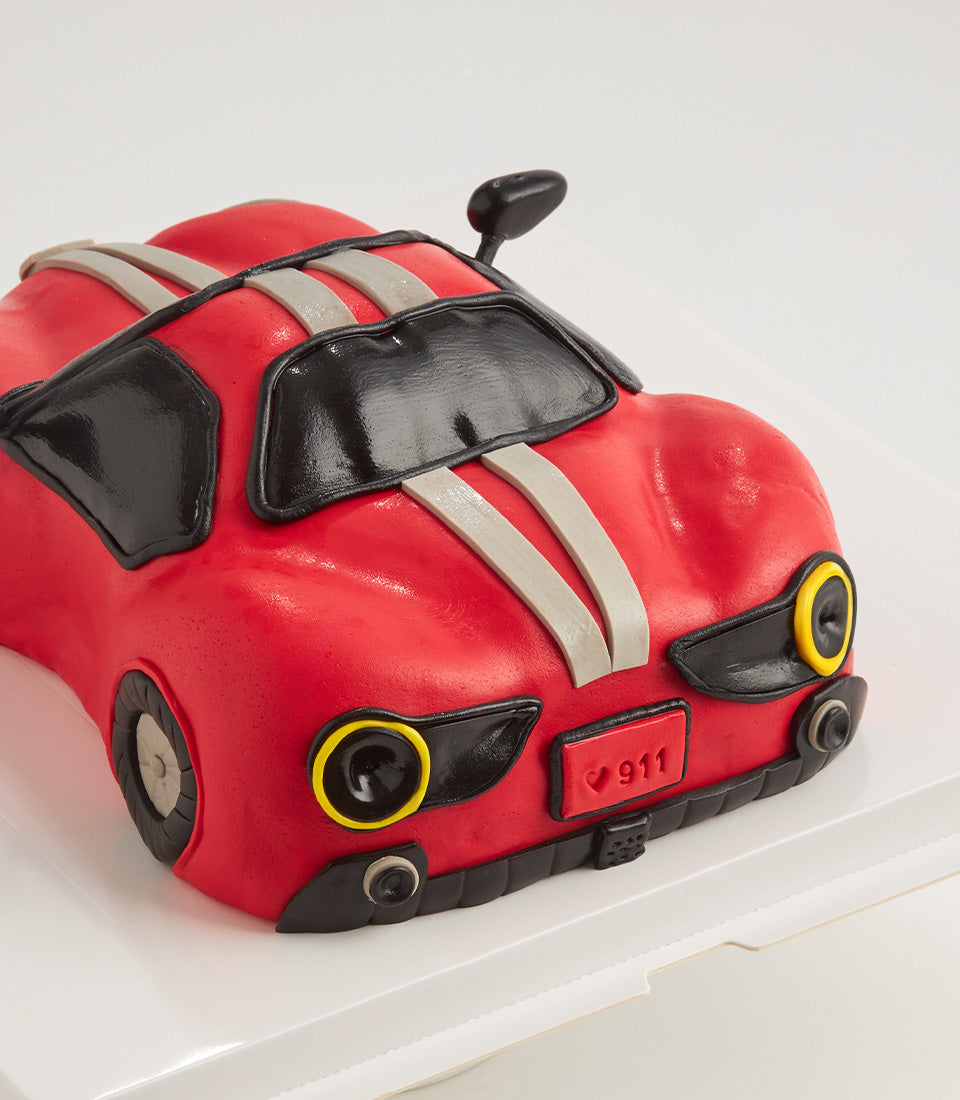 Red sports car-shaped birthday cake with black details and grey racing stripes, 4 lb vanilla celebration cake