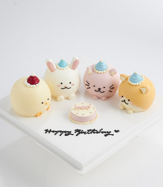 Colorful animal character cakes with party hats and mini HBD cake on white board for children's birthdays