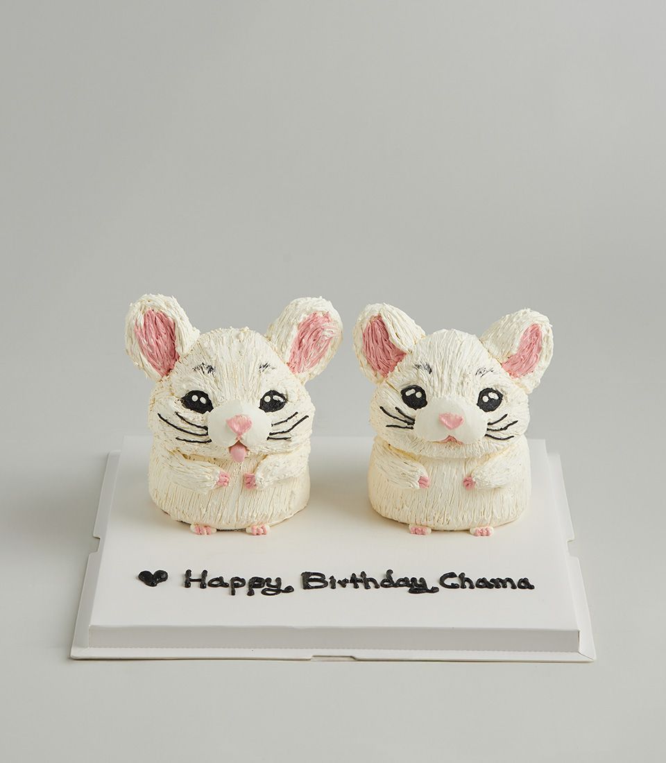 Twin white chinchilla buttercream cakes with pink ears and noses for birthday celebration