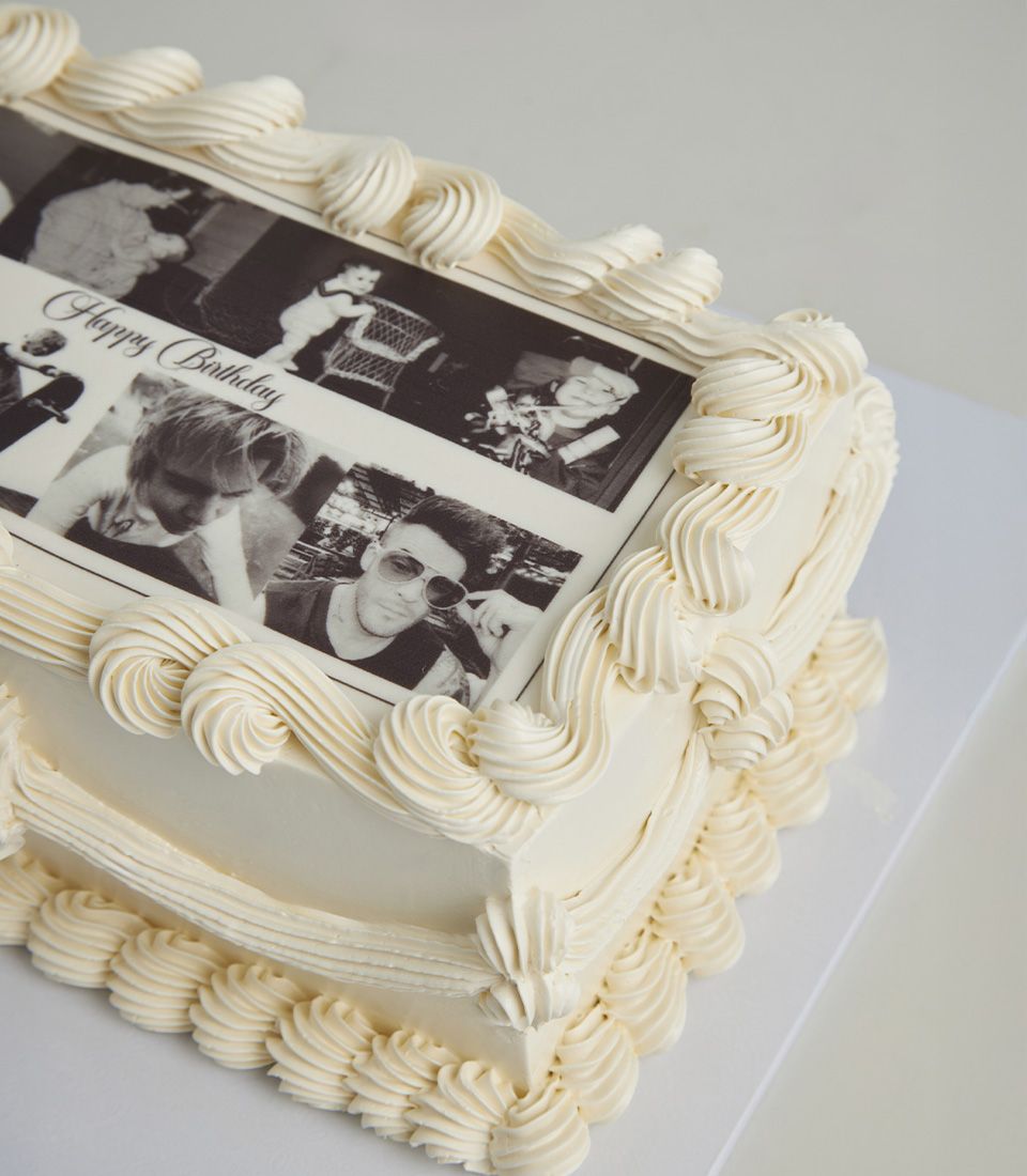 Lemon zest celebration cake with edible photo strip and white buttercream piping