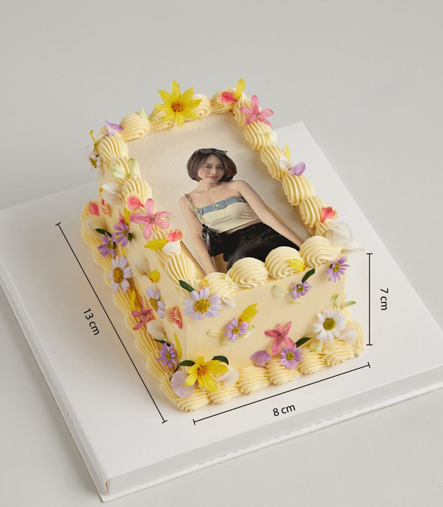 Personalised rectangular vanilla cake with edible photo portrait and colourful sugar flowers