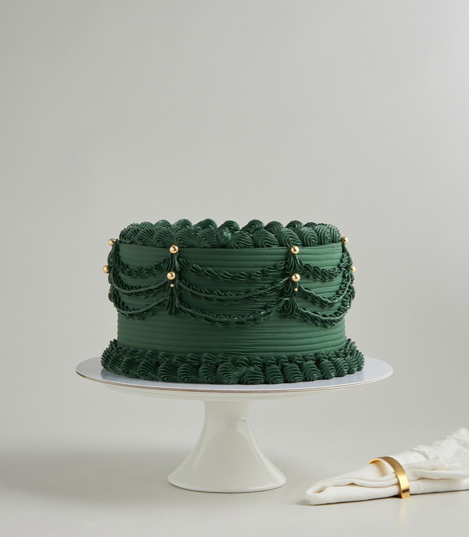 Charlotte Bakery custom cake: Emerald green buttercream birthday cake delivery Bangkok, vintage piped draping and gold pearl accents.