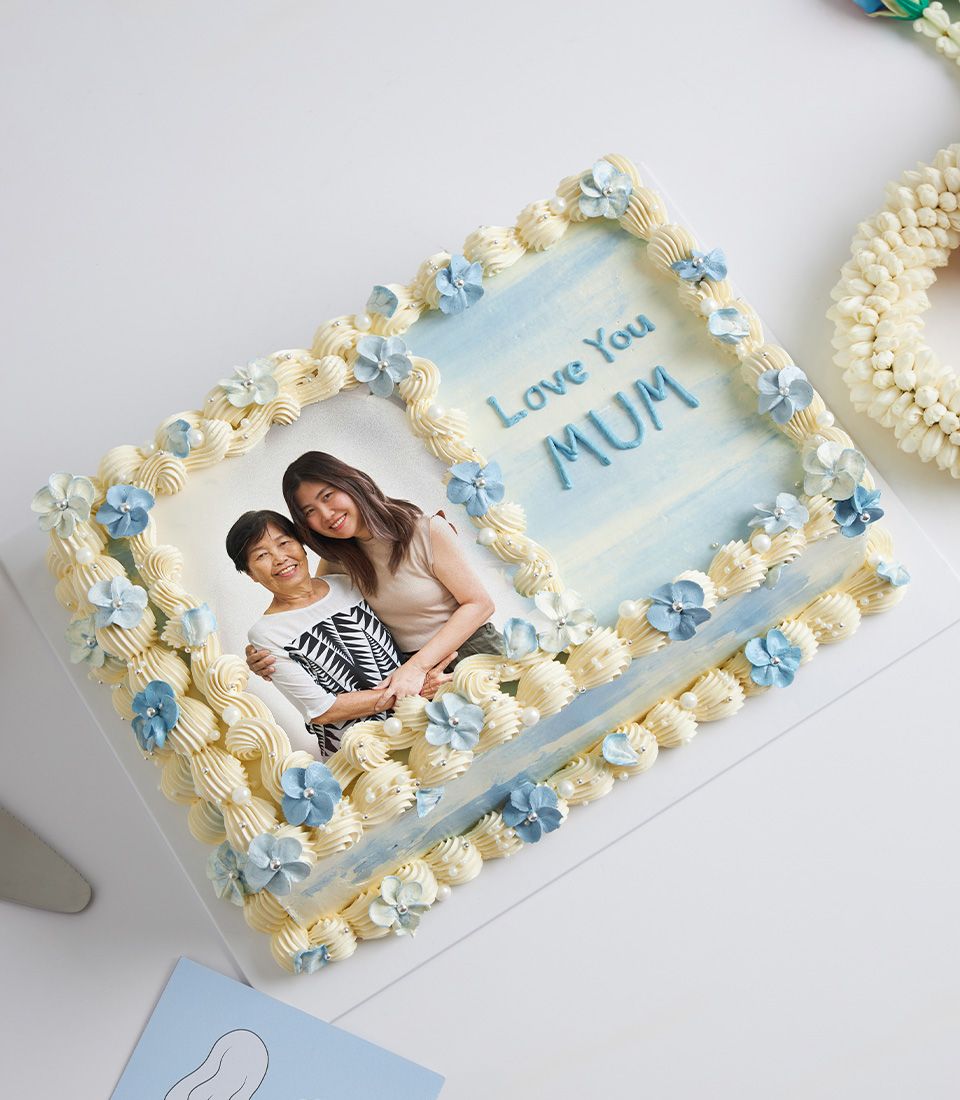 Personalised Mother's Day vanilla cake with edible photo, blue frosting, and edible flowers