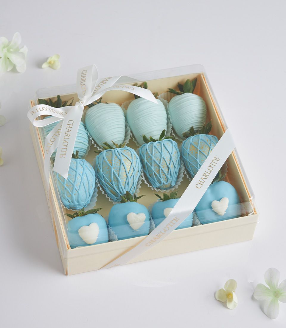 Luxury chocolate-covered strawberries in light blue and white, artisan gift box with gold lattice and heart designs